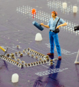 Circuit board with miniature construction workers and camera crew, Fraunhofer IZM